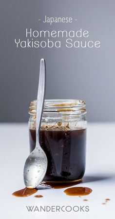 a spoon sitting next to a jar filled with food