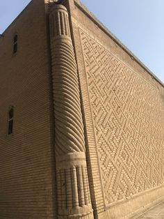 a tall brick building with a clock on it's side