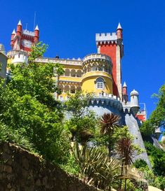 a large castle on top of a hill surrounded by trees