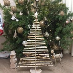 a small christmas tree made out of sticks