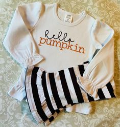 Hello Pumpkin embroidered in brown and orange on white long or short sleeve ruffle tee with coordinating brown striped ruffle pants. Tee also available separately.  Sizes 12m to 10 Fall Cotton Sets With Short Sleeves, Cute Long Sleeve Matching Set Tops, Cute Long Sleeve Sets For Fall, Cute White Sets For Fall, Cotton Fitted Coming Home Outfit Sets, Long Sleeve Cotton Sets For Fall, Fitted Cotton Set For Fall, Fitted Cotton Sets For Coming Home, Cotton Long Sleeve Sets For Fall