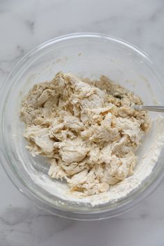 a glass bowl filled with food on top of a white counter