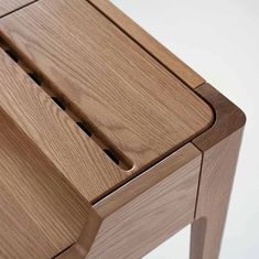 the side view of a wooden table with drawers