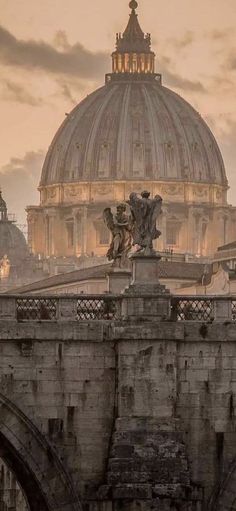 the dome of st peter's cathedral is seen from across the bridge