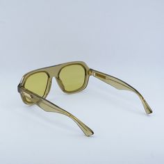 Welcome to Ossa Frames, where we bring you the latest in designer eyewear from top brands like Bottega Veneta. Introducing the Bottega Veneta BV1217S 003 Yellow Crystal/Gold/Mustard aviator sunglasses, a stunning piece that exudes luxury and style. These sleek sunglasses feature a frame color of Yellow Crystal, giving them a unique and eye-catching look that is sure to turn heads. The gold accents on the temples add a touch of elegance, while the Mustard lenses provide a pop of color that is per Yellow Square Frame Sunglasses For Beach, Classic Yellow Sunglasses For Summer, Casual Yellow Aviator Sunglasses With Tinted Lenses, Casual Yellow Shield Sunglasses With Polarized Lenses, Casual Yellow Tinted Aviator Sunglasses, Yellow Tinted Sunglasses For Beach, Yellow Cat Eye Sunglasses With Tinted Lenses, Modern Yellow Cat Eye Sunglasses, Yellow Tinted Beach Sunglasses