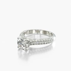 a diamond engagement ring with pave set diamonds on the band and an oval center stone