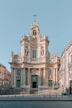 an old building with statues on the front