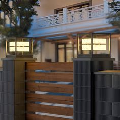 two lamps on top of wooden posts in front of a building with balconies