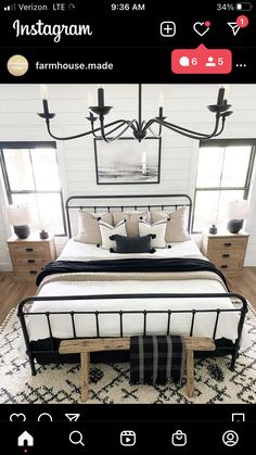 a bedroom with a bed, dressers and chandelier in the middle of it