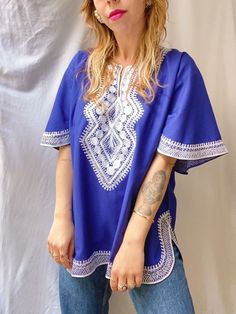 PLEASE NOTE new orders will be shipped after 13th of March due to holiday 💝 please enjoy 15% off the whole collection 💕   Vintage embroidered top, in a bright cobalt blue color. The top is made of pure cotton, with added white embroidery. In a good vintage condition. Fits up to size XL, check measurements to be sure. Model is a size S/M for reference.  size L / XL - measured flat - armpit to armpit: 60cm shoulder to shoulder: 49cm length: 68cm Please compare it with a garment you already own to be sure :) Thank you for visiting my shop <3  { Please read this before shopping } -  Please note that you are buying a vintage garment, garments will not be as new but I check each item very well. Major flaws are always noted in description. Everything is steamed before shipping - All sales are f Traditional Blue Short Sleeve Blouse, Blue Tunic Top With Floral Embroidery, Blue Folk Style Short Sleeve Blouse, Blue Cotton Tunic Top, Blue Cotton Embroidered Short Sleeve Top, Blue Short Sleeve Folk Blouse, Indigo Cotton Top With Floral Embroidery, Bohemian Blue Blouse With Geometric Embroidery, Indigo Cotton Tops With Floral Embroidery