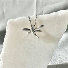 A timeless and classic design, symbolizing strength and everlasting love. Perfect for everyday wear or dressed up for special occasions. Add a pop of color with our Genuine Diamond Dragonfly Pendant, available in 18k solid white gold and 18k solid rose gold. Item Specifications: Materials: 18k Solid Gold  Gemstone: Natural Diamonds  Pendant Diameter 17.5 mm x 12.8 mm Total Gold Weight: 0.98 gram Total Diamond Weight: 0.10 ct Diamond Clarity: SI 1-2  Diamond Color: H color 14k solid yellow gold a Gold Dragonfly Necklace For Gift, Elegant Gold Dragonfly Necklace, Nickel-free Gold Dragonfly Jewelry, Dragon Fly Pendant, Dragonfly Pendant, White Gold Chains, Solid Gold Chains, Diamond Clarity, Diamond Pendant