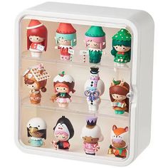 an assortment of small toy figurines in a display case on a white background