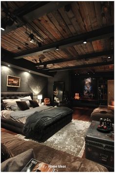 a large bed sitting in the middle of a bedroom next to a tv on top of a wooden wall