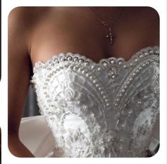 the back of a wedding dress with pearls on it