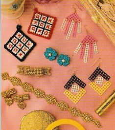 there are many different pieces of jewelry on the pink tablecloth, including earrings and bracelets