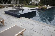 an empty swimming pool surrounded by patio furniture