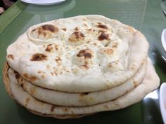 a stack of pita bread sitting on top of a table