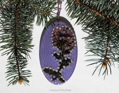 an ornament hanging from a pine tree