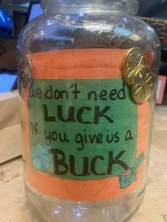 a glass jar with a label on it that says, we don't need luck if you give us a buck