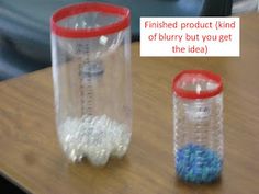 two plastic containers sitting on top of a wooden table next to each other, one with blue and white beads in it