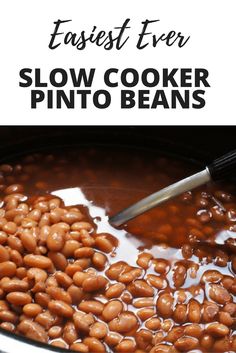 slow cooker pinto beans in a pot with text overlay reading easy ever slow cooker pinto beans