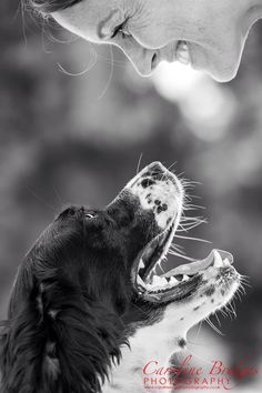 a black and white photo of a dog with its mouth open