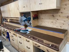 a workbench with many drawers and tools on it