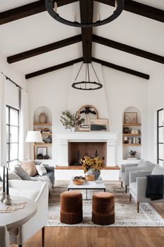 a living room filled with furniture and a fire place in the middle of a room