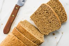 slices of bread sitting on top of a cutting board next to a knife