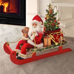 a santa clause sitting on a sleigh next to a christmas tree and fireplace