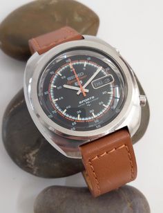 * VIDEO INCLUDED. An absolutely stunning vintage "SEIKO SPORTS SPEED-TIMER" automatic wristwatch reference 7017. This is the classic 1970's "Seiko 5 Sports Speed-Timer" Day/Date stainless steel wristwatch reference with an automatic 23 jewel movement, made in Japan. The watch has a large size 40mm stainless steel case with an immaculate black and orange "Suwa" dial with a mirrored chapter ring and a day/date feature at the 3.00 position and an orange seconds hand. I feel this is the best colour Seiko Presage 60s, Men’s Seiko Watches, Seiko Sport, Grand Seiko Spring Drive, Seiko Spring Drive, Seiko Spb143, Seiko 5 Sports, Seiko 5, Good Color Combinations