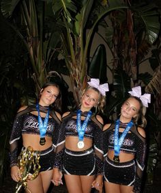 three cheerleaders are posing for the camera