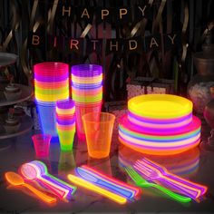 neon colored plastic cups, forks and spoons on a table