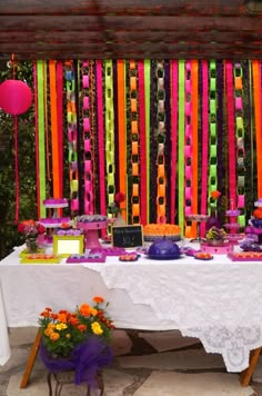 the table is covered with colorful ribbons and decorations