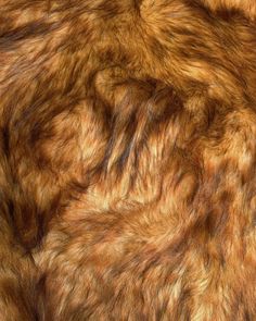 an animal fur texture is shown in brown and orange tones, as well as black spots