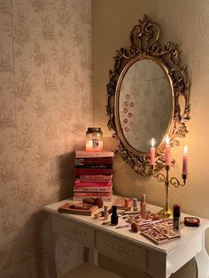 a vanity with candles and books on it