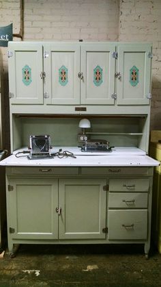 an old fashioned stove top oven sitting inside of a kitchen next to a brick wall