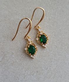 14k Gold Plated Hook Earrings with Emerald Gemstone Charms, Vintage Style Earrings, Filigree Charms, Emerald Hook Earrings Product specifications: * Material: 14K Gold Plated Brass * Size 3.7cm drop length. Each charm measures 2cm. Packaging and Gifts: * All pieces of jewellery are set on a card in a mesh jewellery pouch Shipping: * All orders will be shipped out within 1 - 3 days by standard untracked letter post. If you require tracking, please upgrade to that option at the time of checkout. I Dainty Emerald Earrings Gift, Dainty Emerald Earrings As A Gift, Green 14k Gold Earrings For Wedding, Green 14k Gold Wedding Earrings, Elegant Green Jewelry With Lever Back Ear Wires, Dainty Gold Earrings With Emerald, Dainty Gold Emerald Earrings, Jewellery Pouch, Vintage Style Earrings