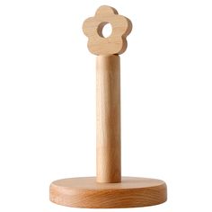 a wooden toy with a flower on it's top and a stick in the middle