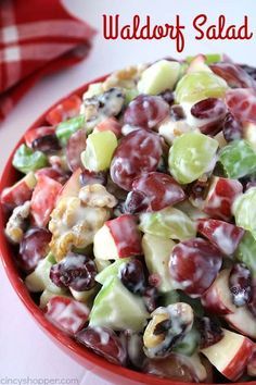 a red bowl filled with fruit salad on top of a table