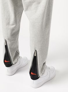 zip-detail track pants from NIKE featuring light grey, cotton, zip details, elasticated waistband, two diagonal pockets to the sides and elasticated cuffs. | Nike Zip-Detail Track Pants Nike Track Pants Outfits, Nike Track Pants Mens, Sporty Outfits Men, Track Pants Outfit, Pants Outfit Ideas, Designer Sweatpants, Old Clothes Refashion, Sweatpants For Men