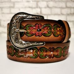 EMBOSSED LEATHER BELT FOR WOMEN This leather belt for women is a dream accessory; a versatile piece you'll love and wear forever. Sumptuous LEATHER in rich brown tones is embossed with flowers and finished with a classic engraved buckle. The vintage vibe and Western-inspired design make it the perfect partner to your trusty blue jeans and boho dresses. •Made of GENUINE LEATHER and has a metal buckle•HANDMADE by talented artisans for an authentic look•EMBOSSED LEATHER , engraved buckle,•Features Luxury Vintage Engraved Belts, Rodeo Gifts, Bohemian Cowgirl, Leather Engraved, Cowgirl Belts, Handmade Leather Belt, Boho Belts, Handmade Belts, Beautiful Belts