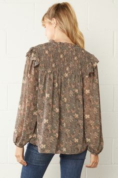 This top is so feminine, trendy & fun. We love the pretty floral print. It's simple, comfy & flowy fit make it so easy to style for work or play! This blouse features a split V-neckline with tie, long sheer sleeves with elastic at the wrist, ruffle detailing at the neck, is lined, has smocking on the shoulder area, is light weight and has a relaxed silhouette. Small Bust 42" Length 26" Medium Bust 44" Length 26" Large Bust 46" Length 26" 100% Polyester - No stretch hand wash or dry clean importe Versatile Flowy Spring Blouse, Flowy V-neck Blouse For Fall, Trendy Flowy Floral Print Blouse, Versatile V-neck Blouse With Floral Print, Chic Ditsy Floral Print Long Sleeve Tops, Chic Long Sleeve Tops With Ditsy Floral Print, Spring Long Sleeve Blouse With Ditsy Floral Print, V-neck Ditsy Floral Print Blouse For Fall, Ditsy Floral Print V-neck Blouse For Fall