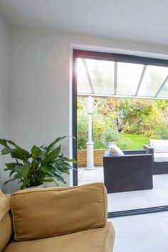 a living room filled with furniture and a sliding glass door