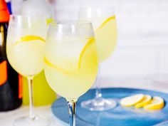 two glasses filled with lemonade sit on a blue plate