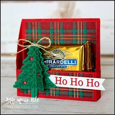 a red box with some candy and a christmas tree on it