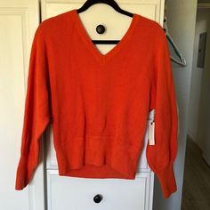 Orange V Neck Sweater Trendy Orange V-neck Sweater, Fitted Soft Knit V-neck Casual Sweater, Casual Ribbed Knit V-neck Sweater, Casual Ribbed V-neck Knit Sweater, Cozy Orange Knit Top, Orange Knit V-neck Top, Orange V-neck Knit Top, Fitted Knit V-neck Sweater Casual Style, Casual Fitted Soft Knit V-neck Sweater