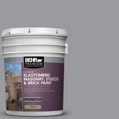 a bucket of paint with the words behr premium on it and an image of a house in the background