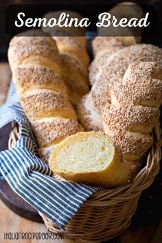 a basket filled with loaves of bread on top of a wooden table