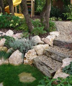 a garden with rocks and plants in it